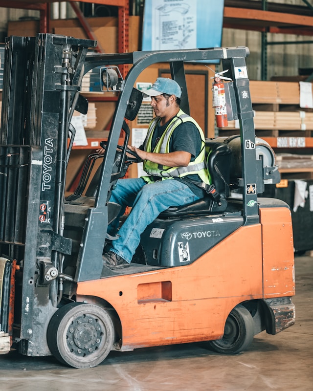 Forklift operator working in a warehouse